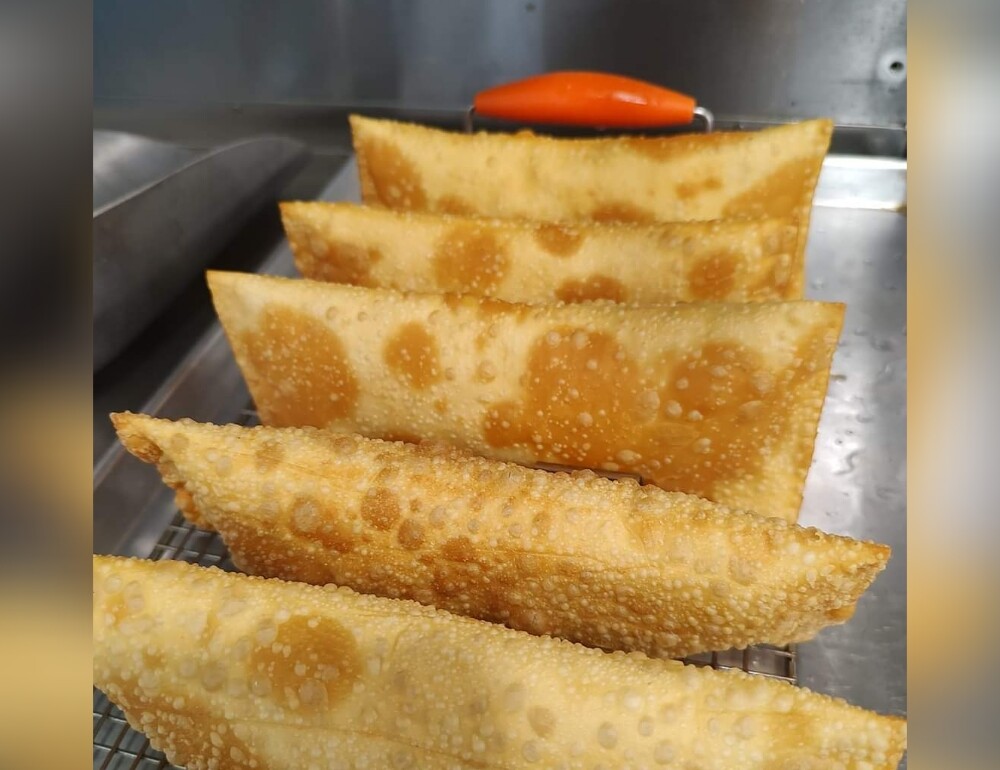 Golden fried Brazilian pastéis fresh from the fryer